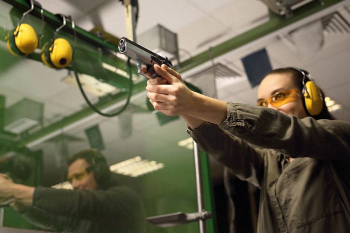 woman gun range train shoot