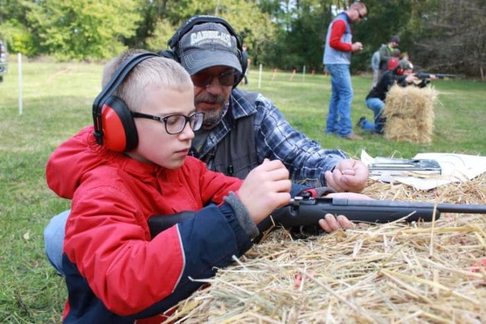 kids father son shooting train rifle learn to shoot